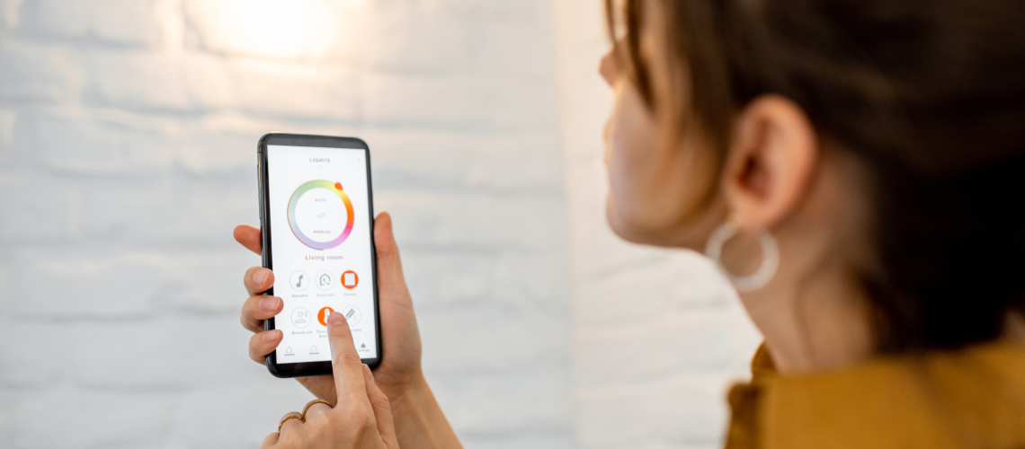Woman holidng phone that controls Smart Outdoor Landscape Lighting